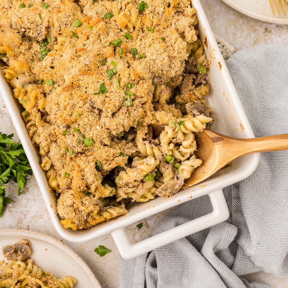 Tuna Casserole with wooden spoon, ready to scoop.