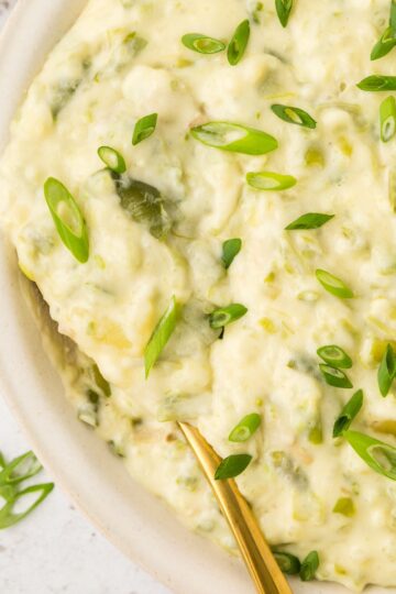 Green Bean Smashed Potatoes served in a bowl with a spoon.