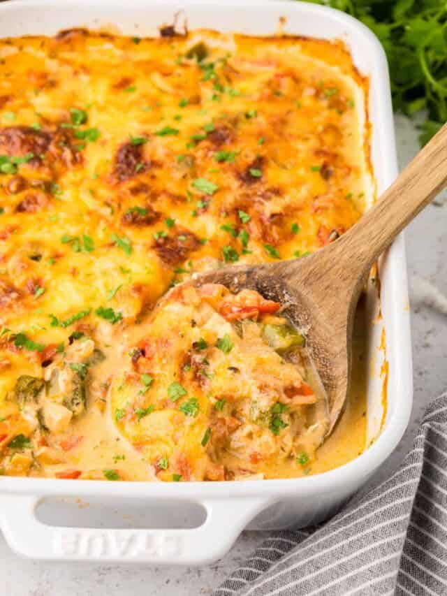 Fish Casserole in baking dish with wooden serving spoon.