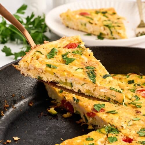 chicken frittata slice being taken out of the pan