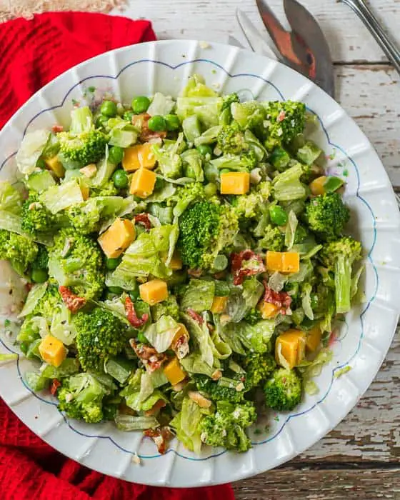 top shot of broccoli bacon salad in a white bowl