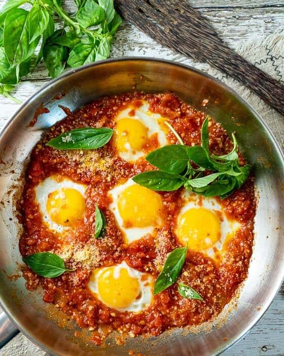 top shot of eggs in purgatory in a stainless steel pan