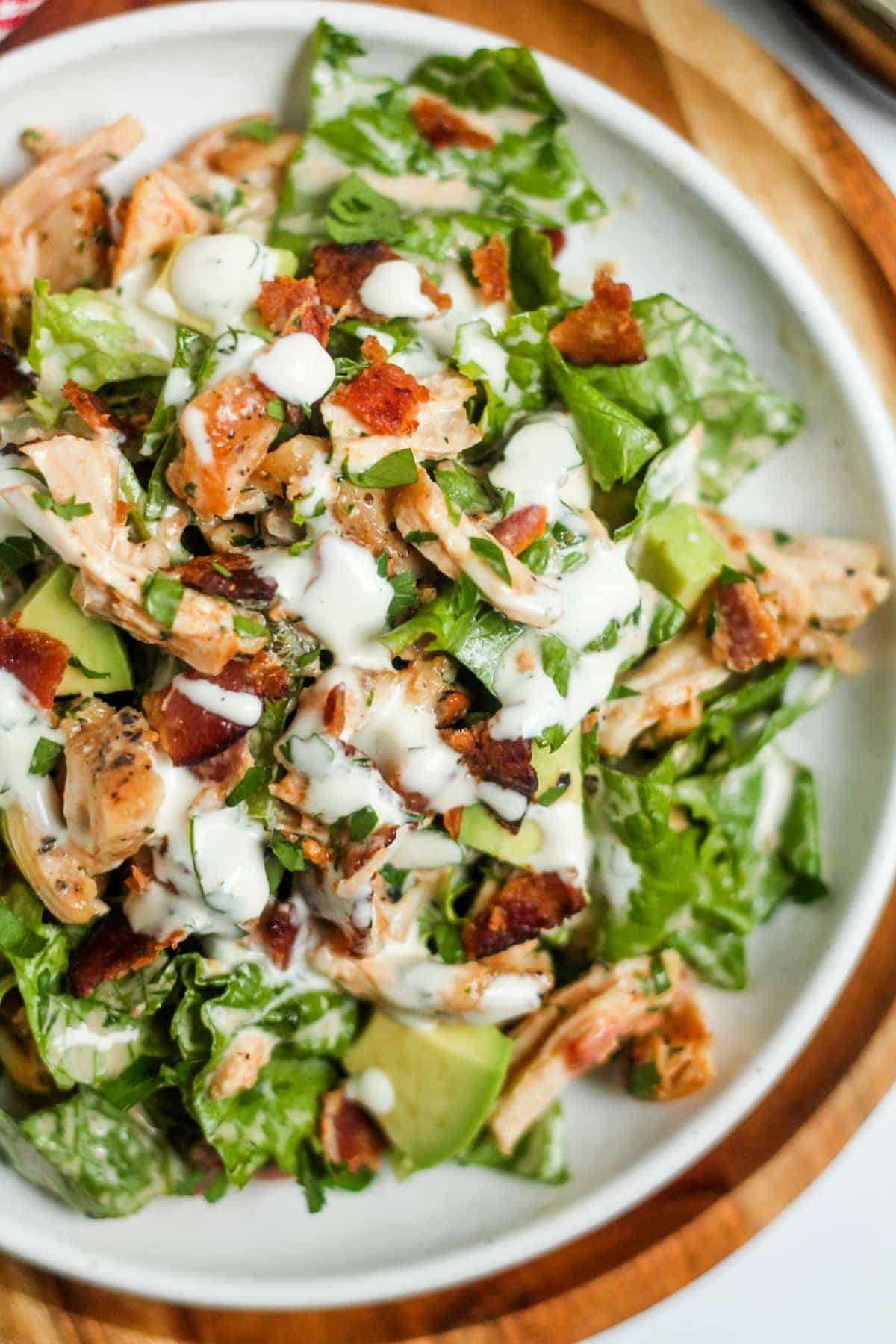 Salad with lettuce, shredded chicken, bacon, avocado-perfect for healthy salad recipes.
