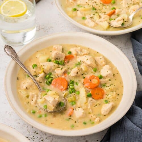 Instant Pot Chicken Stew served in bowls with a glass of lemon water.