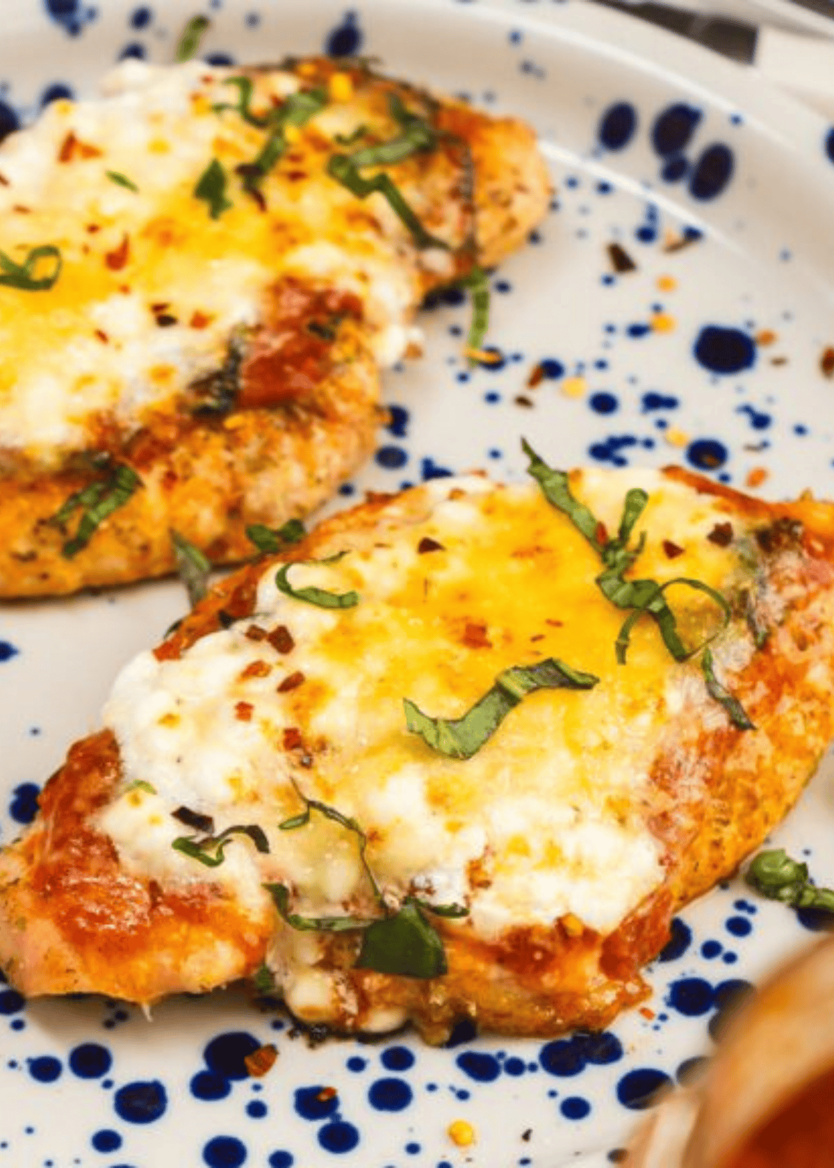 Enjoy easy chicken breast recipes with baked chicken breasts, cheese, tomato sauce, and fresh basil.