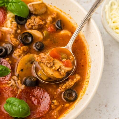 Pizza Soup in a bowl with a spoon.
