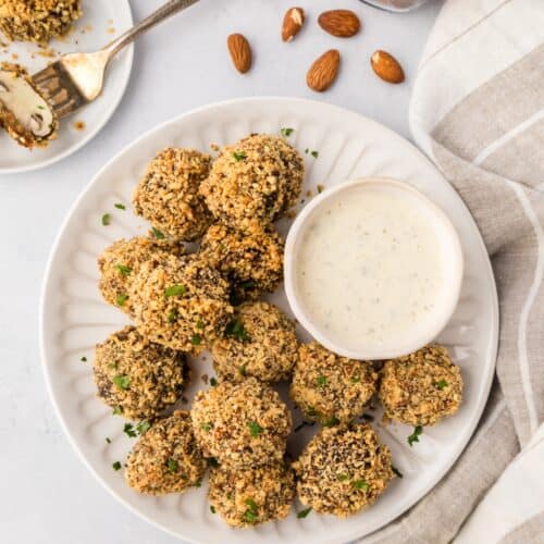 almond crusted mushrooms served on a white dish