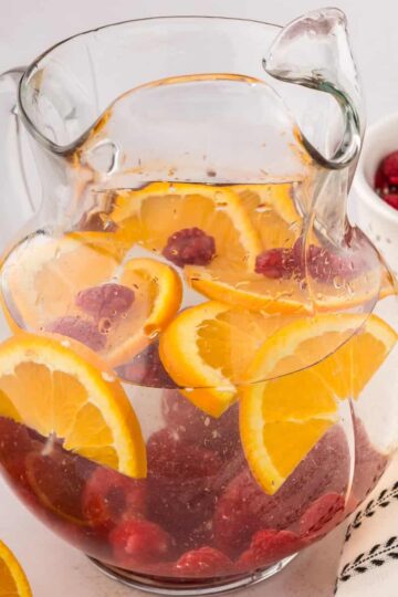 raspberry infused water in a pitcher