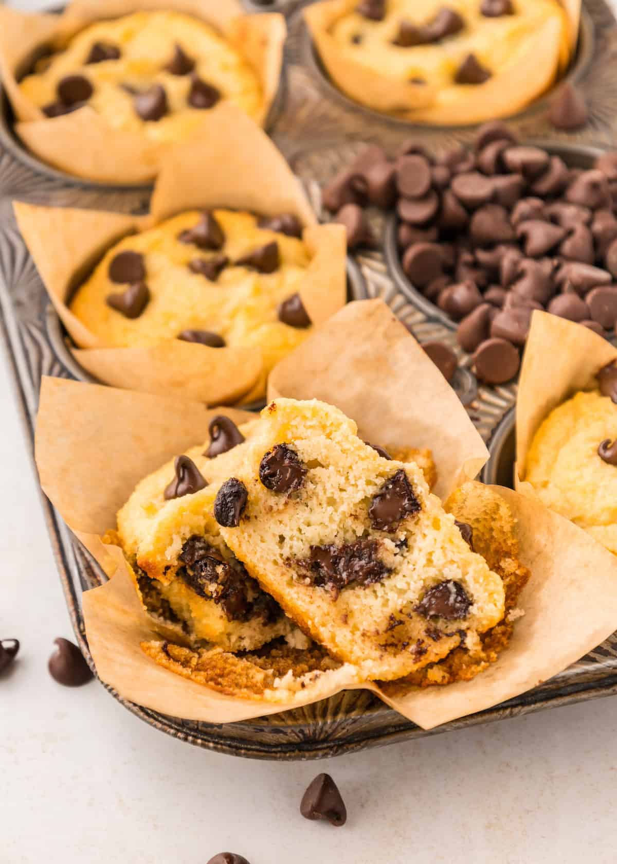 healthy chocolate chip muffin ripped open, showing melty chocolate chips