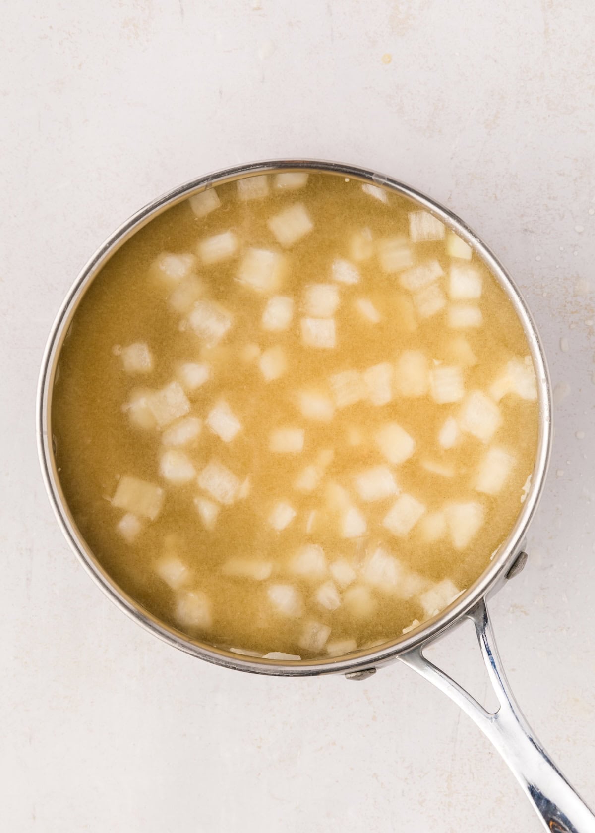Sauce pan with roux and chicken broth.