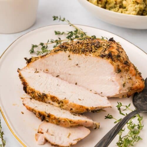 herb roasted turkey breast sliced on an oval platter