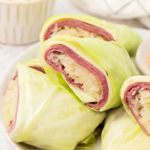 Reuben Wraps stacked on plate.