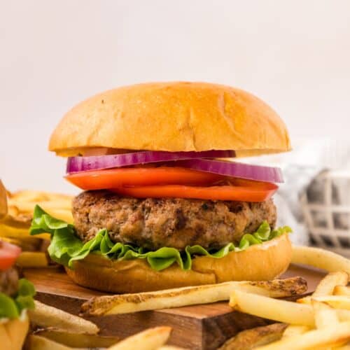 Turkey Burger with toppings, bun, and french fries.