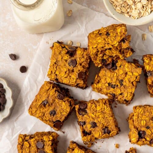 Pumpkin Bars on parchment paper, served with milk.