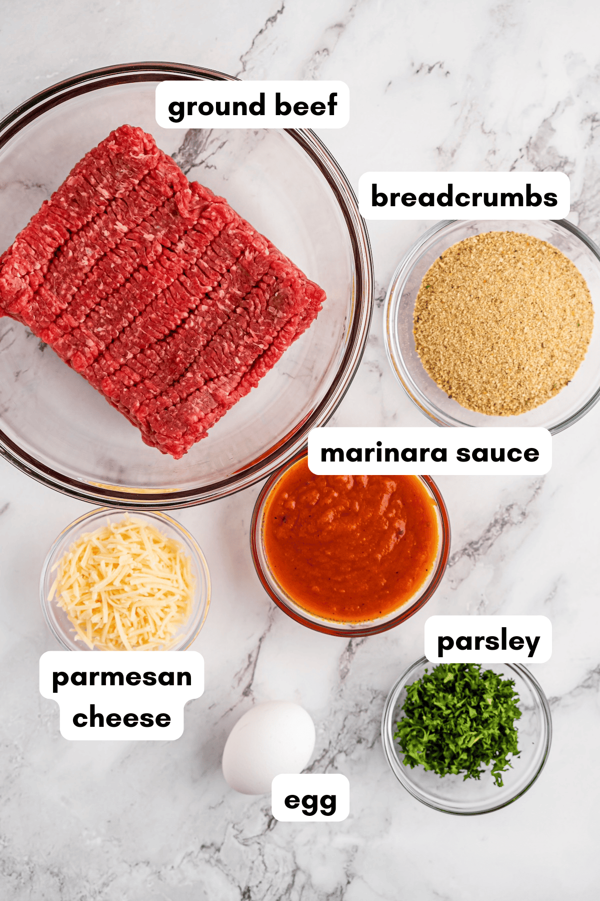 Ingredients for meatballs: ground beef, breadcrumbs, marinara, parmesan, parsley, and egg.