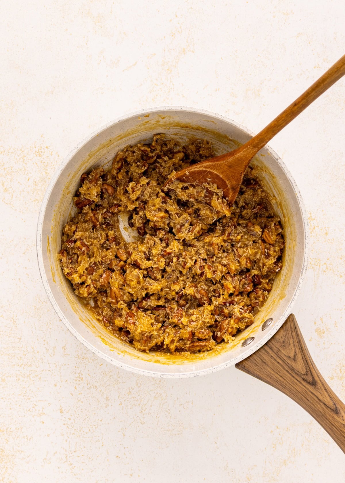 A bowl of food with a wooden spoon and German chocolate brownies.