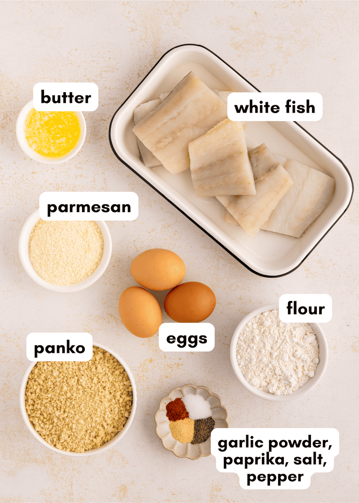 Homemade Fish Sticks made with white fish, parmesan, panko, eggs, flour, and spices.