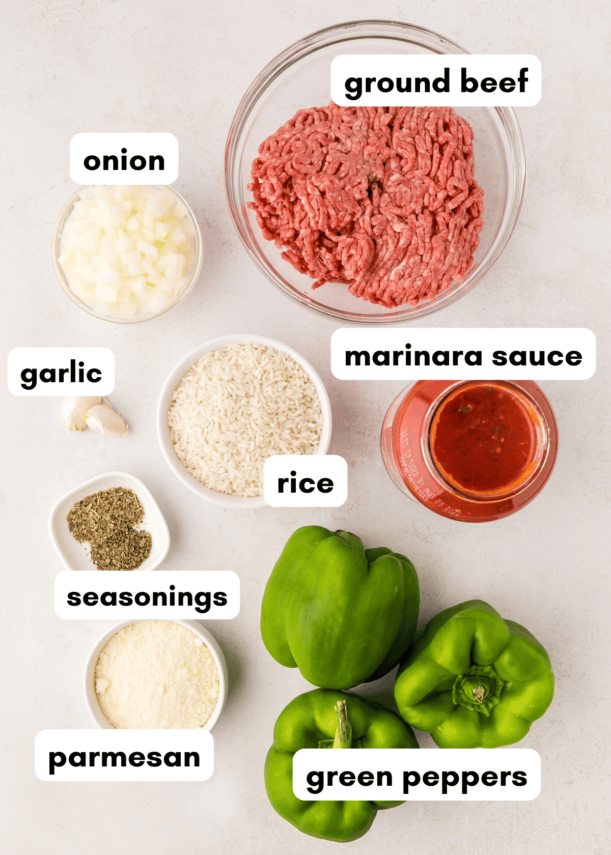 Ingredients for stuffed peppers, including ground beef, rice, green peppers, and seasonings.