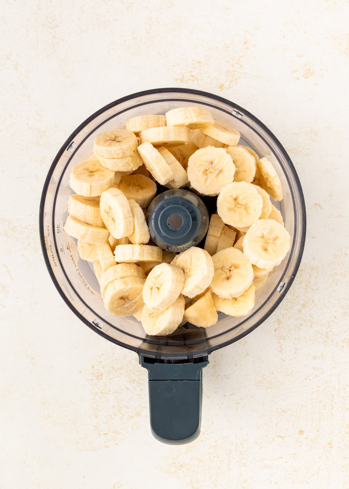 Sliced bananas in a food processor.