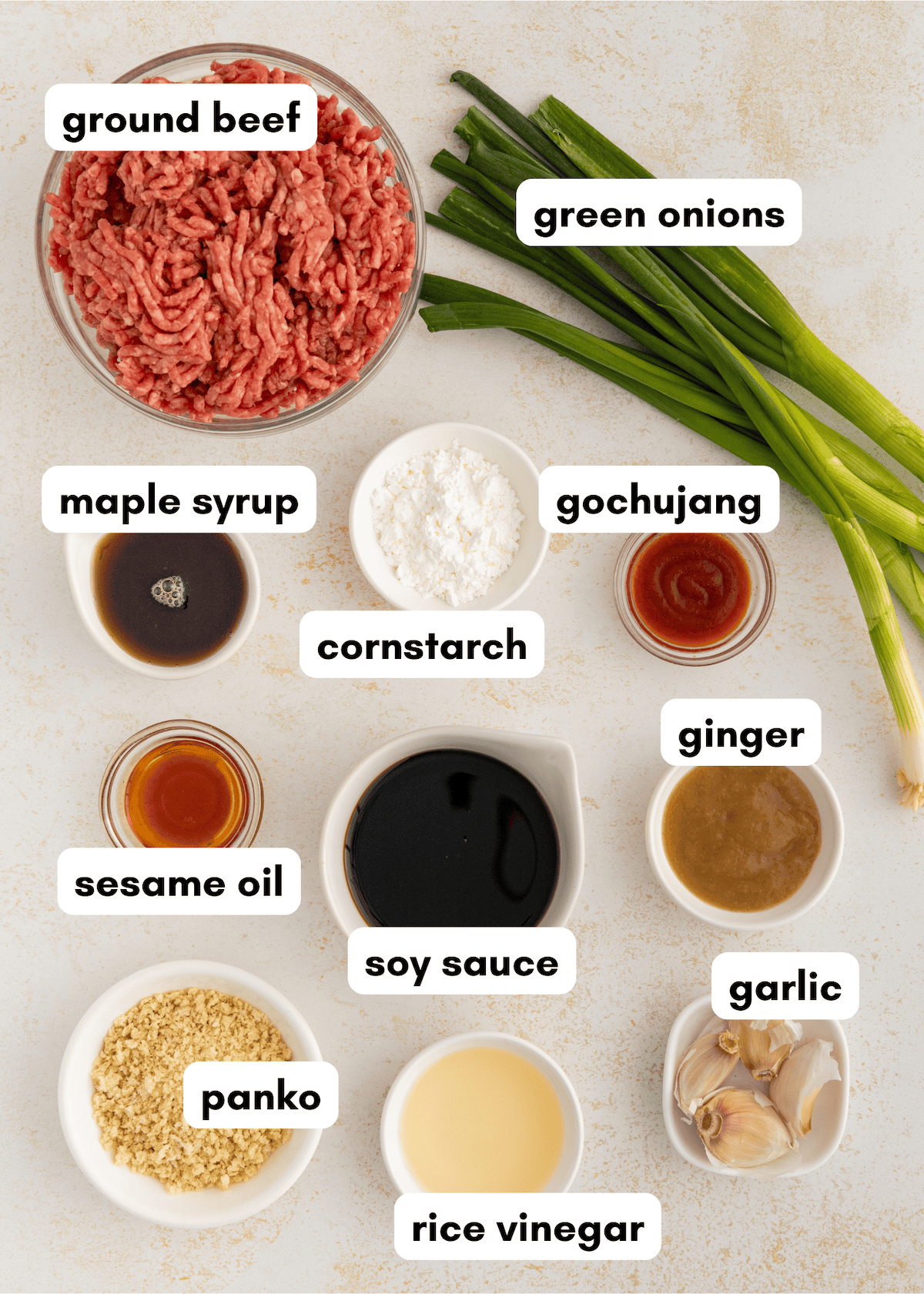 Labeled ingredients for Korean BBQ meatballs, including ground beef, green onions, and sauces.