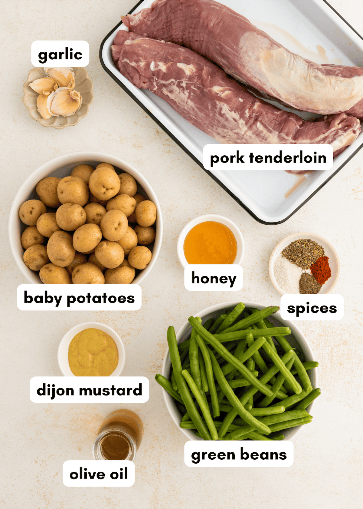 Raw pork tenderloin, baby potatoes, green beans, garlic, honey, spices, mustard, and olive oil.