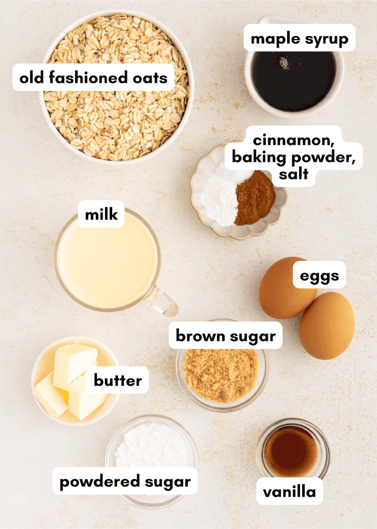 Ingredients for Cinnamon Roll Baked Oatmeal: oats, milk, eggs, butter, sugars, spices, and vanilla.