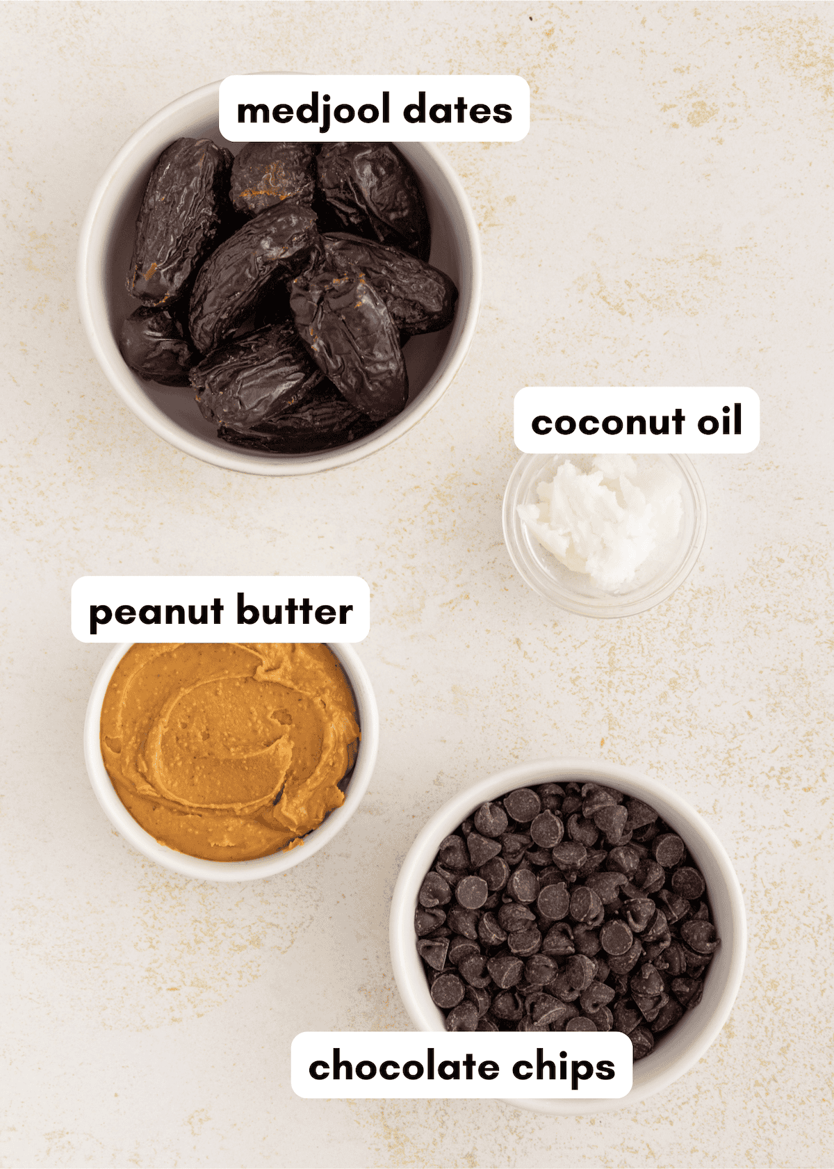 Four labeled bowls: medjool dates, coconut oil, peanut butter chocolate dates, and chocolate chips.