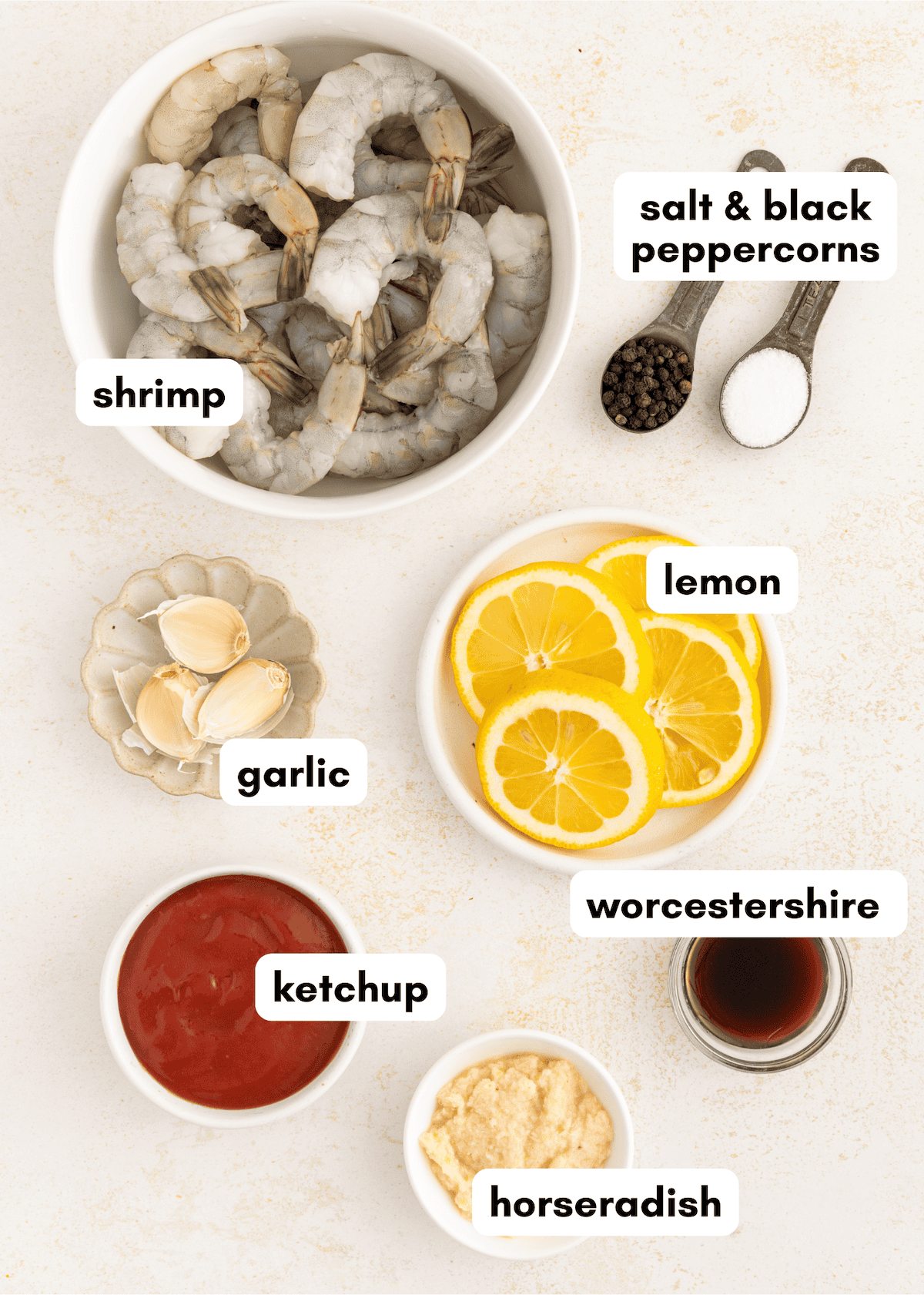 Shrimp, lemon slices, garlic, ketchup, horseradish, Worcestershire, salt, and peppercorns.
