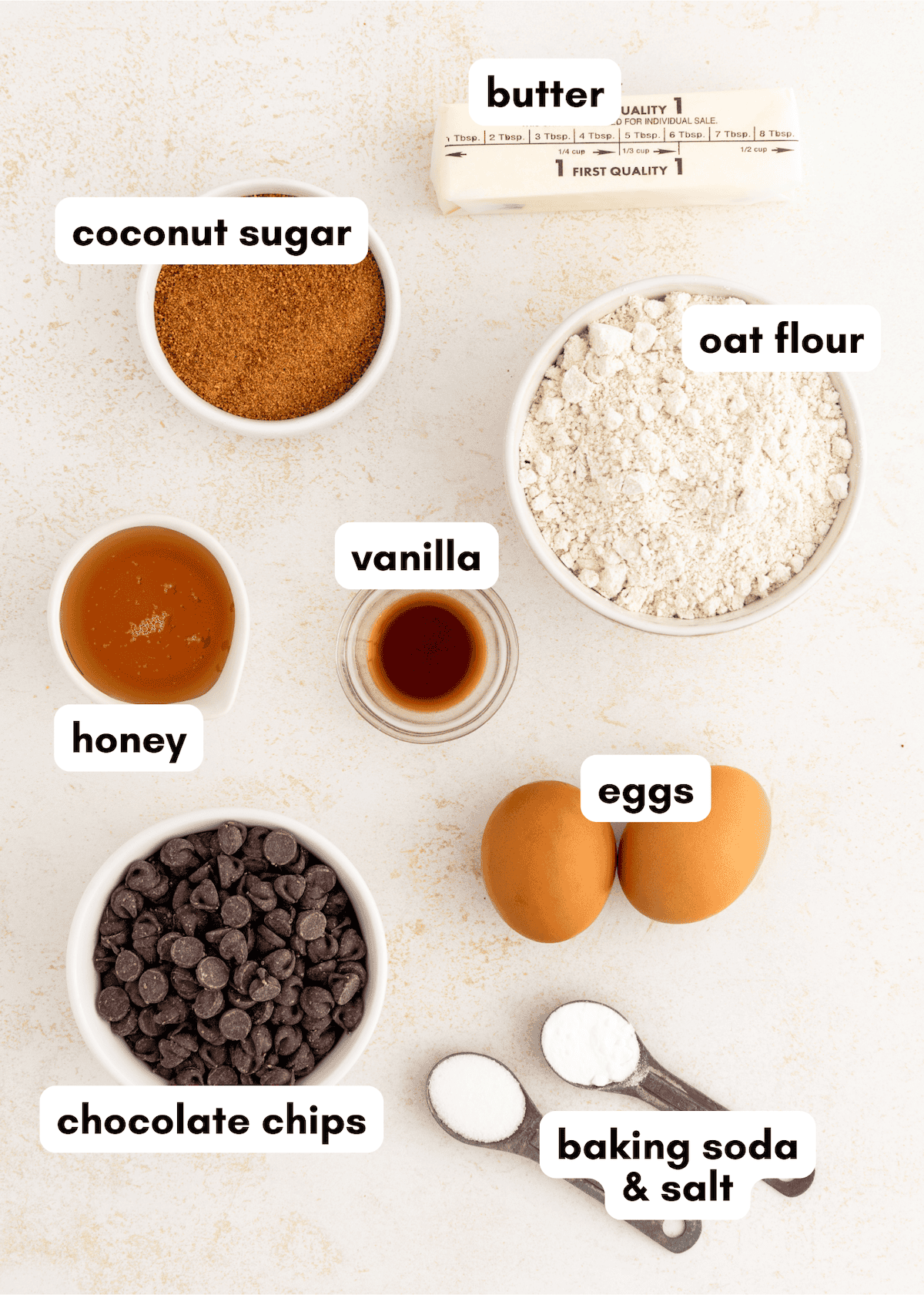 Labeled baking ingredients: butter, coconut sugar, oat flour, honey, vanilla, eggs, chocolate chips.
