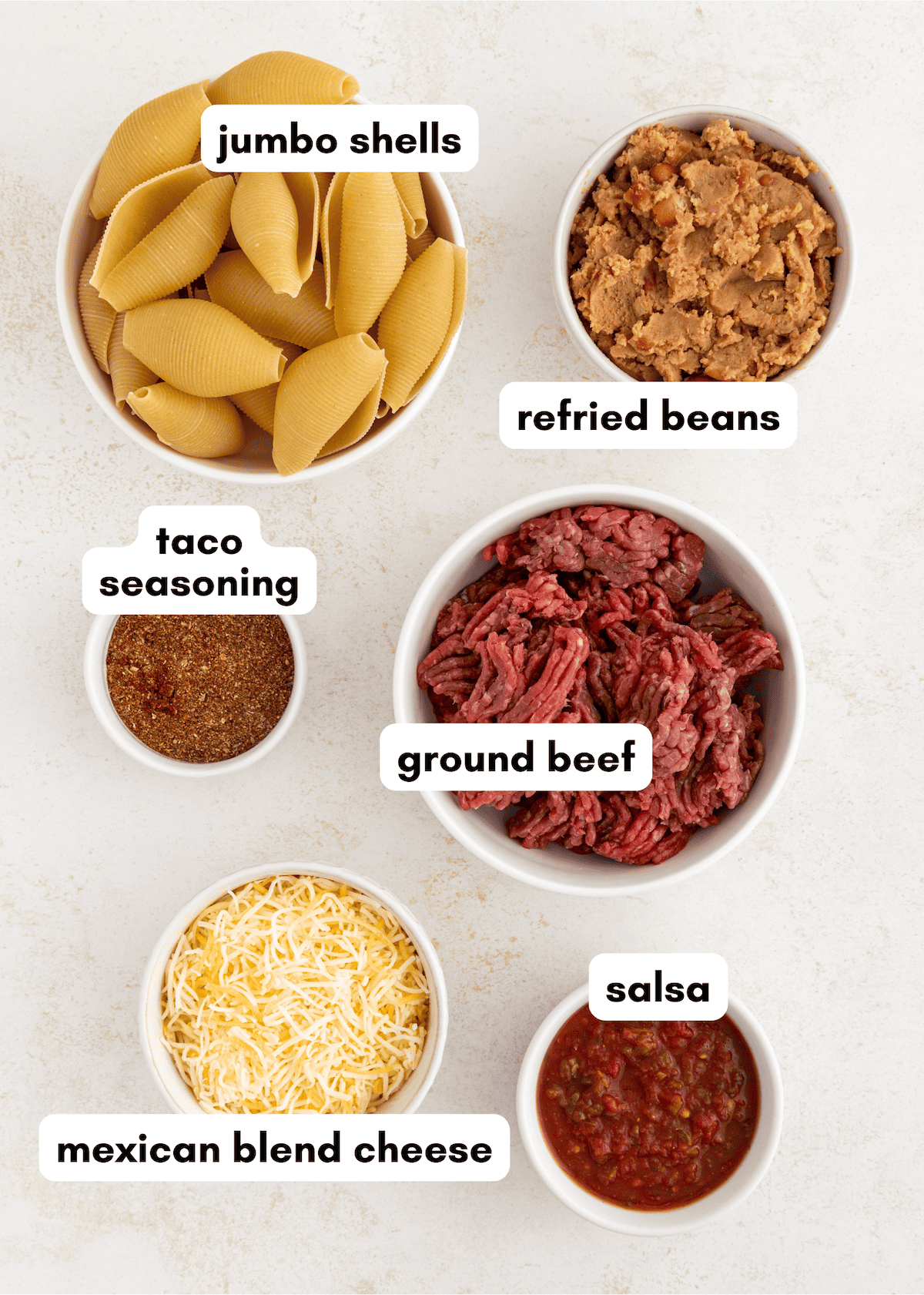 Jumbo shells, refried beans, taco seasoning, ground beef, salsa, and Mexican blend cheese.
